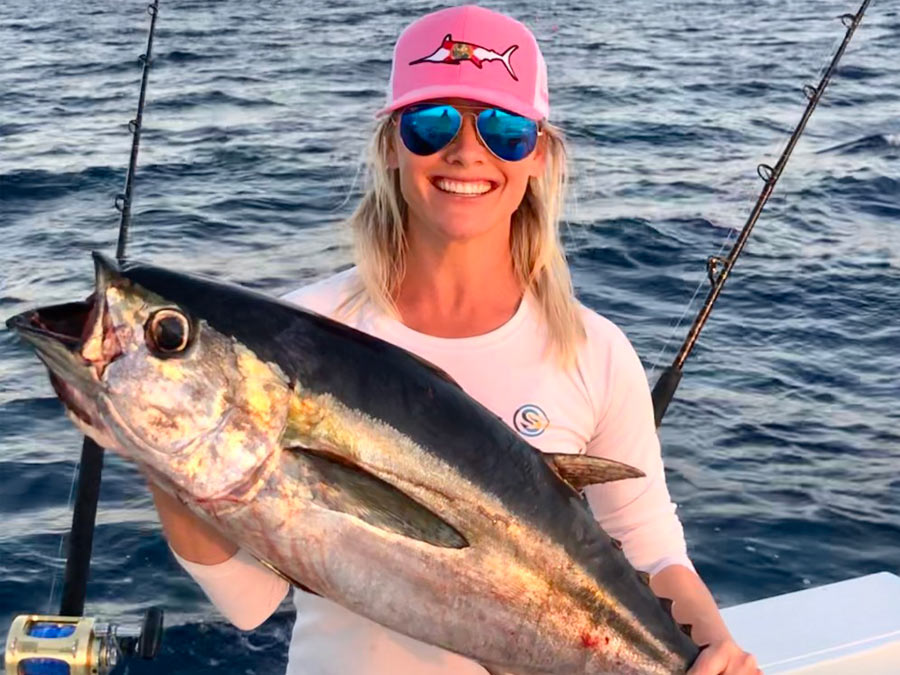 woman holding blackfin tuna